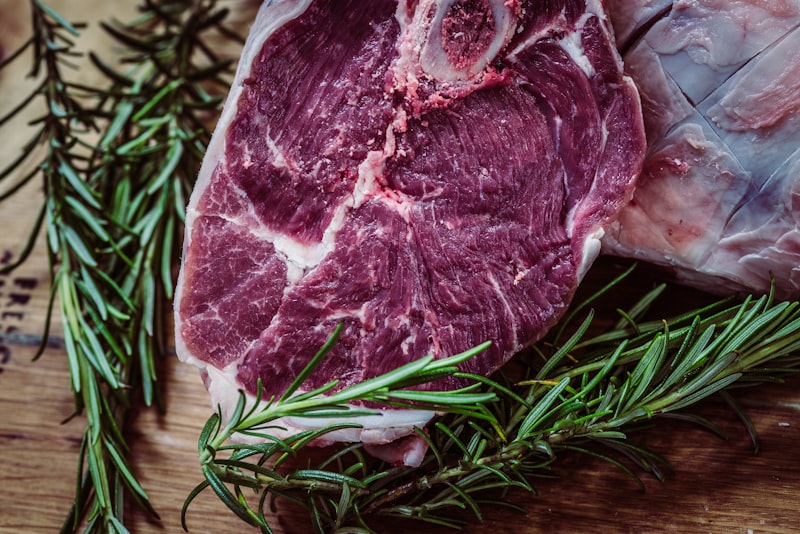 Butcher preparing fresh cuts behind the counter at Pinjarra Meat Supply